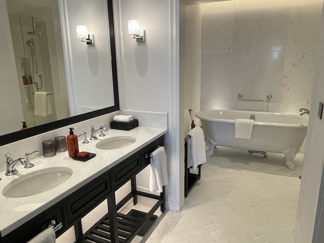 a bathroom with a tub and sinks