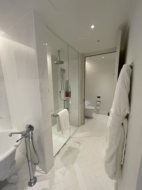 a bathroom with a bathrobe and a tub