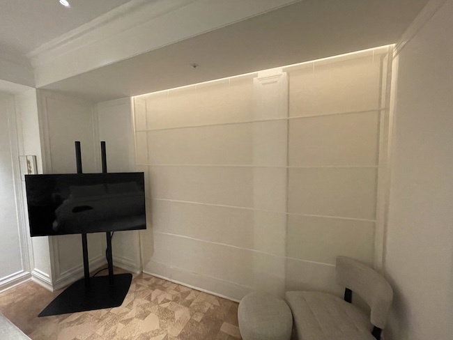 a room with a tv and chair