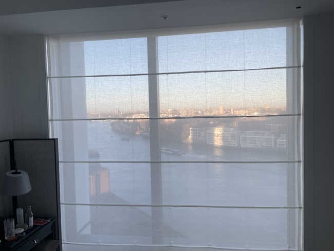 a window with a view of a city and water