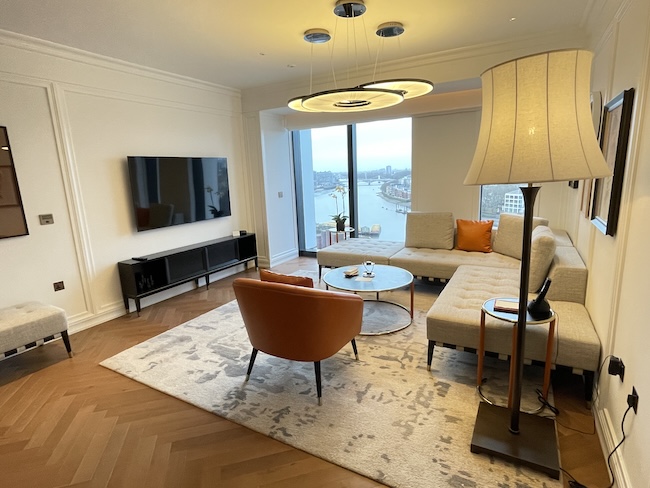 a living room with a large window and a large television