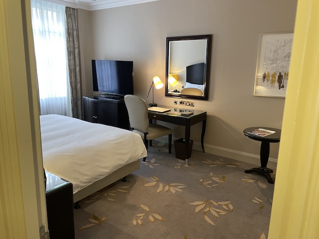 a bedroom with a bed and a television