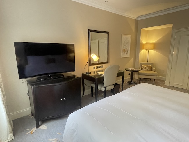 a room with a bed and a television