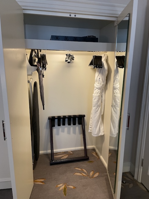 a closet with white robe on swingers