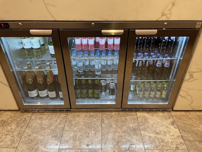 a refrigerator with bottles of alcohol