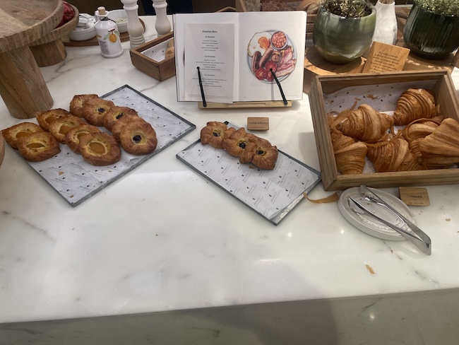 a table with pastries and croissants