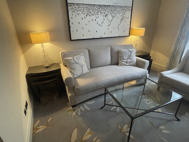 a living room with a couch and a glass coffee table