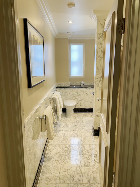 a bathroom with marble floor and toilet