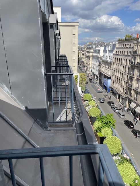 a balcony with a railing and a street in the background