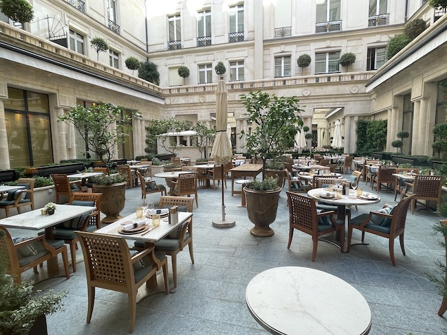 a courtyard with tables and chairs