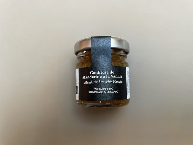 a small glass jar with a black label