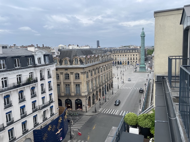 a city street with buildings and a statue