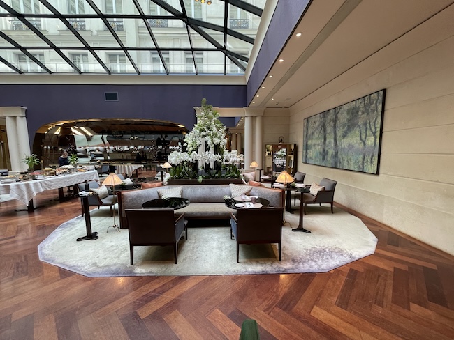 a room with a large glass ceiling and a large table and chairs