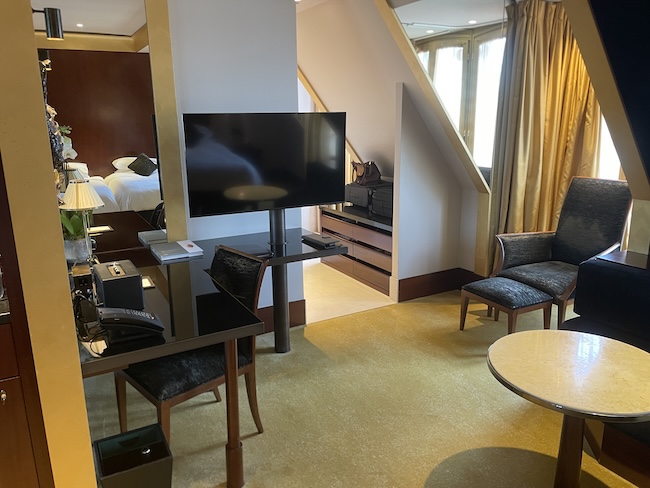 a room with a television and chairs