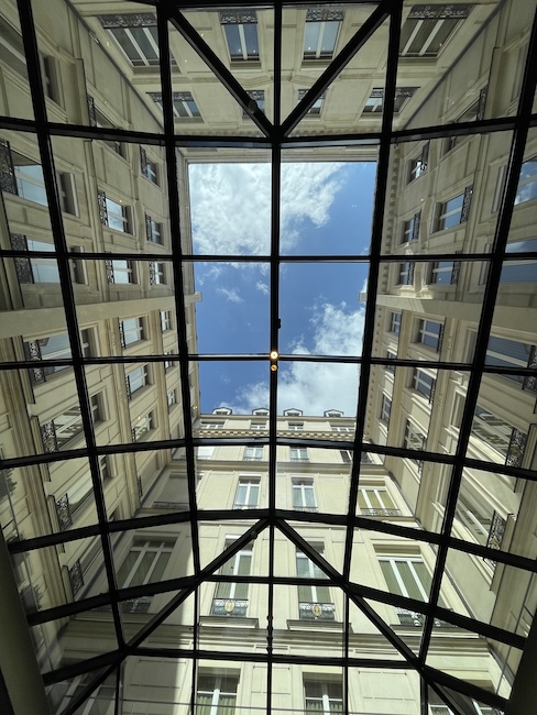 looking up at a skylight through a glass roof