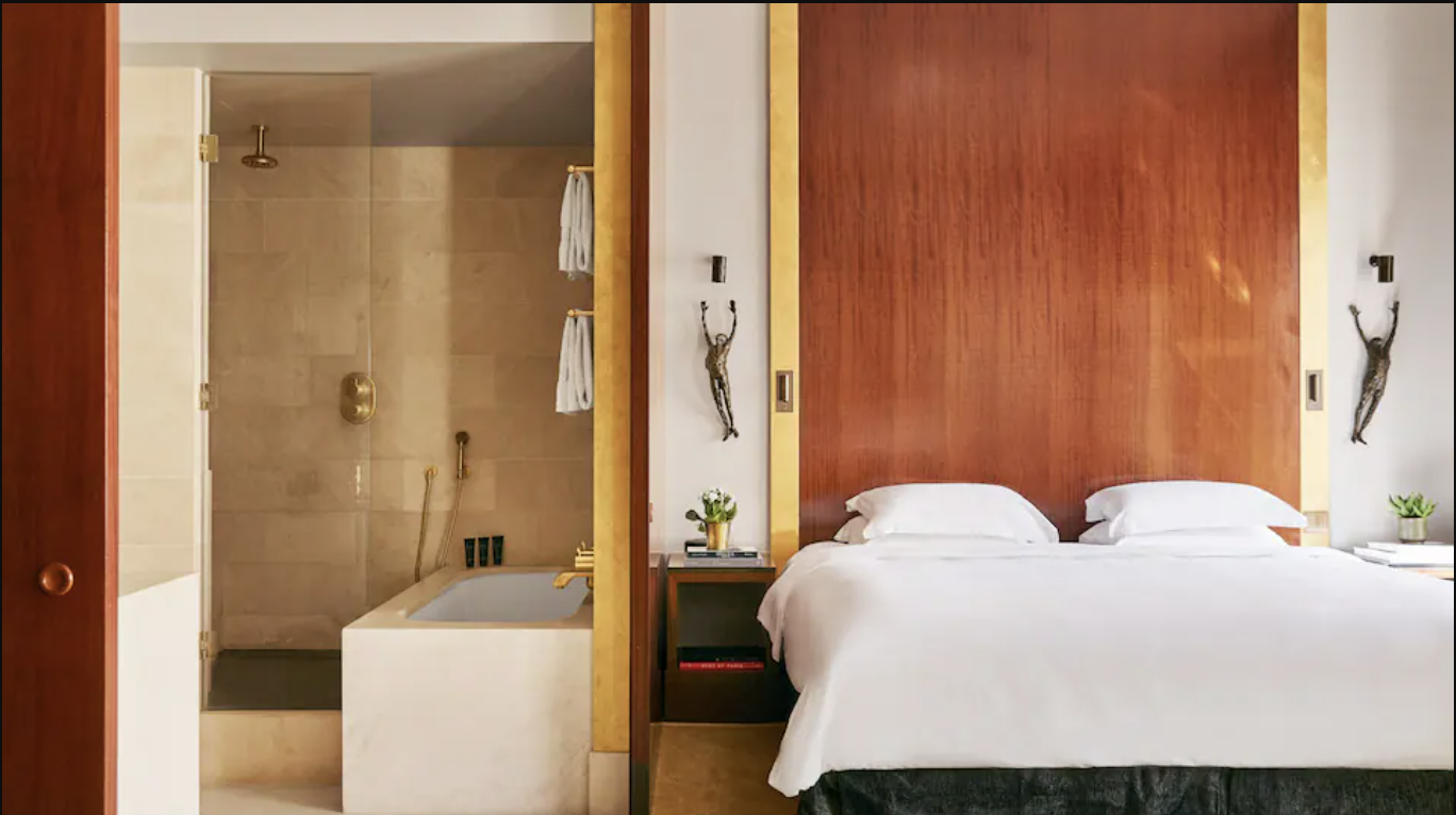a bed and bathtub in a hotel room