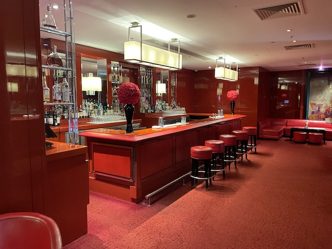 a bar with red walls and red carpet