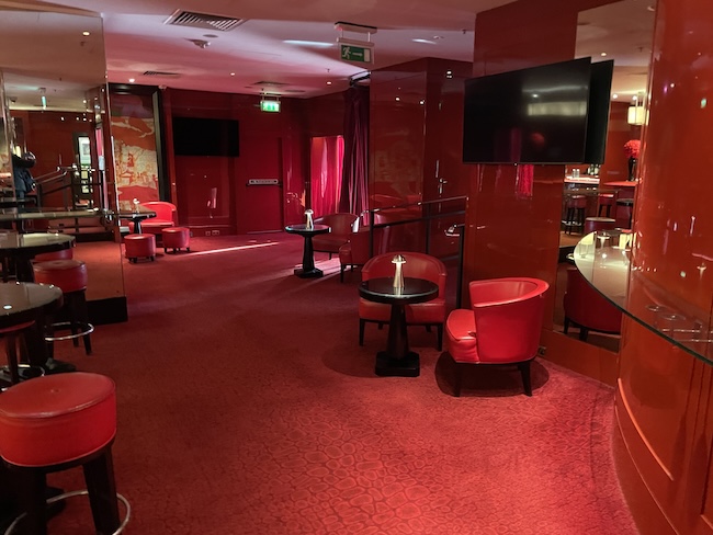 a room with red walls and tables and chairs