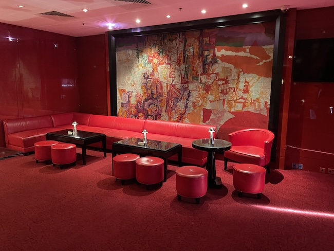 a room with red couches and tables
