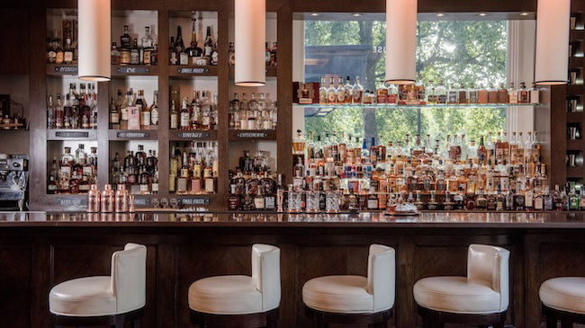 a bar with many bottles of alcohol