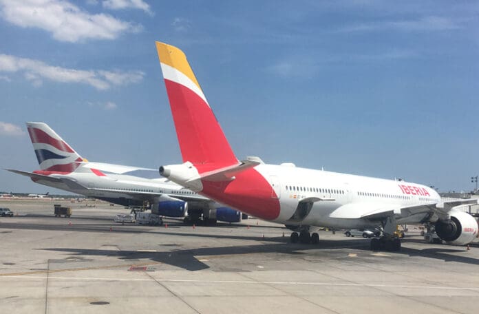a group of airplanes parked on a runway