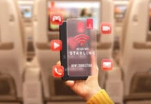 Emirates is the latest airline to add Starlink WiFi to its fleet a hand holding a phone