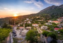 a town with a road and cars parked on it