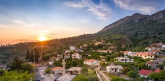 a town with a road and cars parked on it