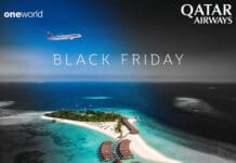 an island with buildings and a beach in the background