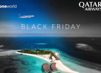 an island with buildings and a beach in the background