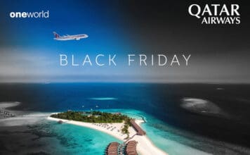 an island with buildings and a beach in the background