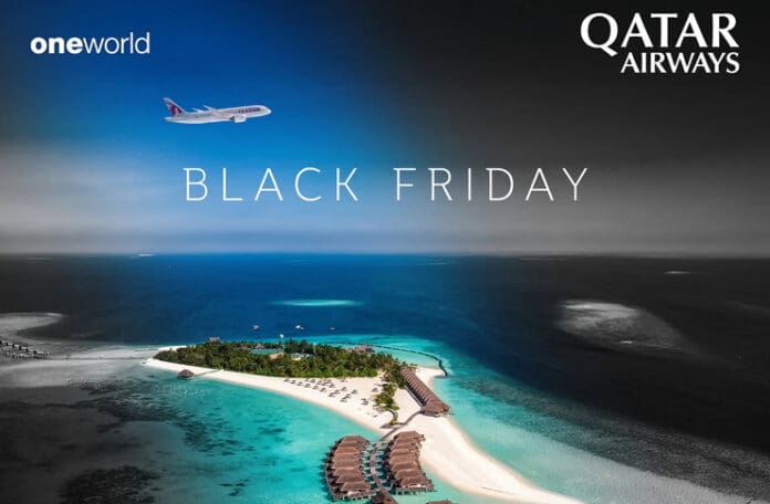 an island with buildings and a beach in the background