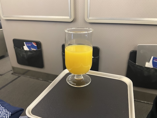 a glass of orange juice on a table