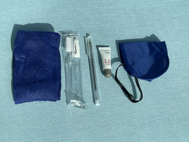 a blue cloth with a toothbrush and toothpaste
