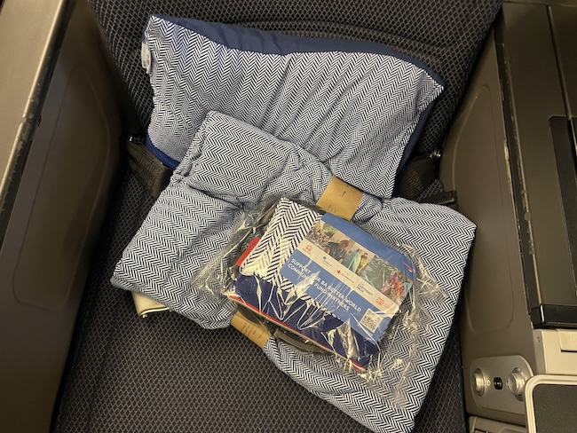 a pillow and blanket in a seat
