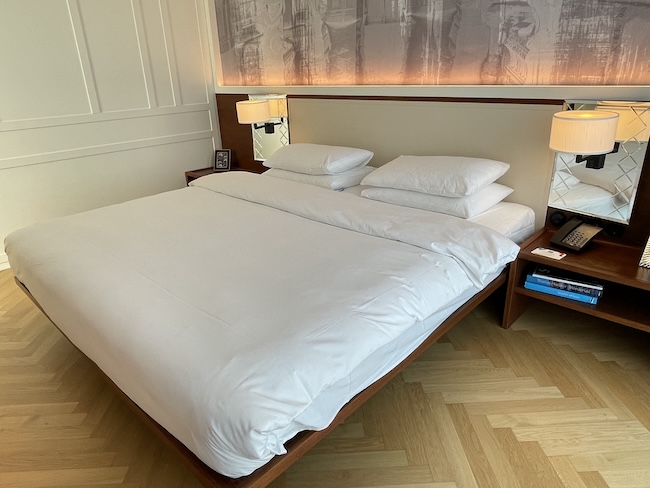 a bed with a lamp on the side