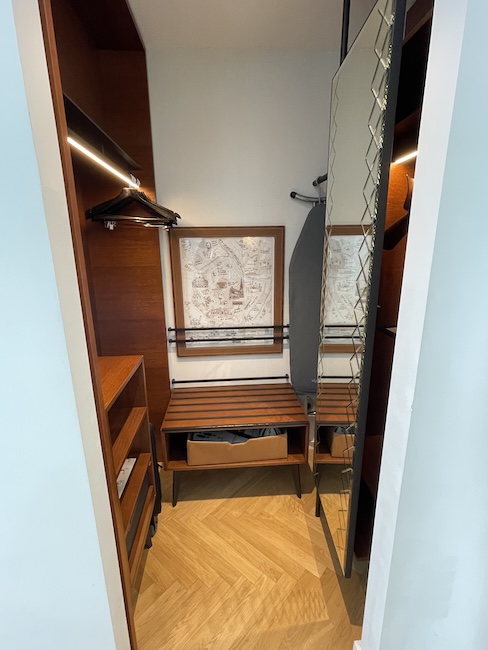 a closet with a bench and shelves