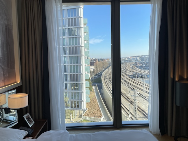 a window with a view of a city and a train track