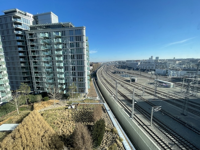 a train tracks next to a building