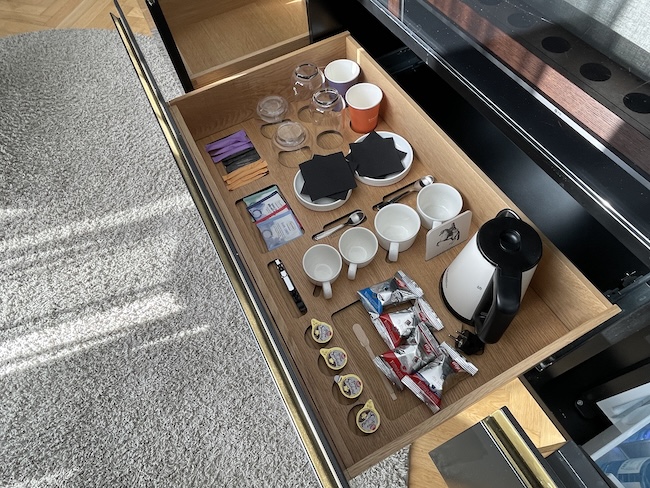 a drawer with coffee cups and teacups