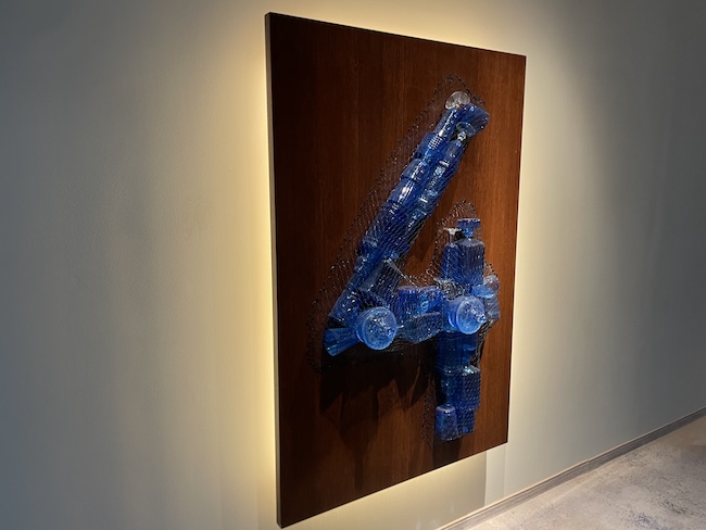 a blue bottle art on a wall