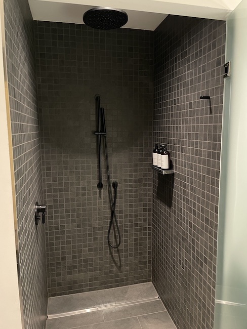 a shower with a shower head and a shower head