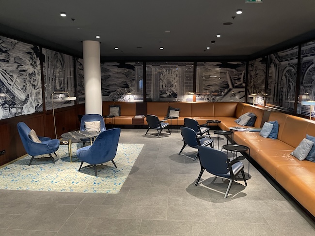 a room with a couch and chairs