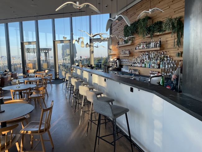 a bar with many chairs and tables