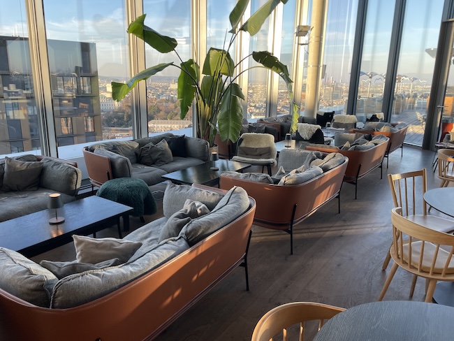 a room with couches and tables and chairs