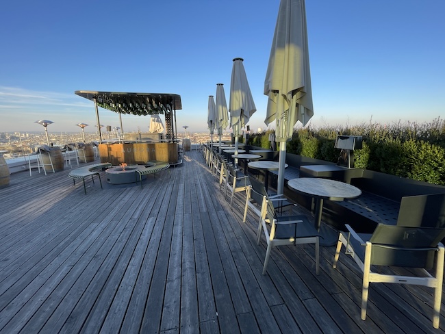 a patio with tables and chairs and umbrellas