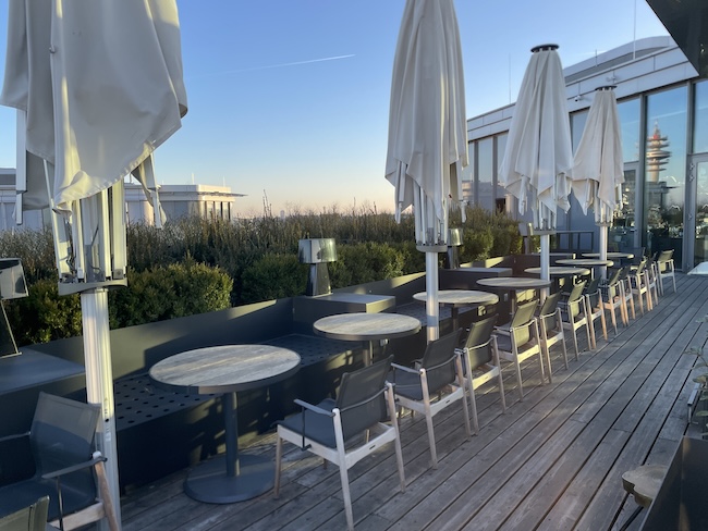 a patio with tables and chairs