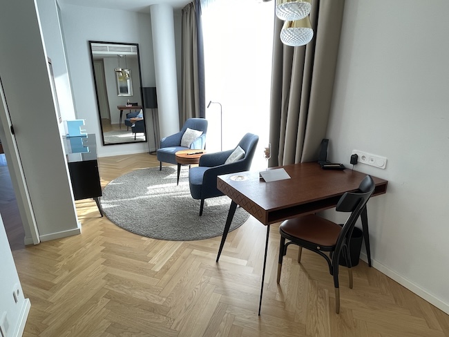 a room with a desk and chairs